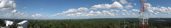 Panorama from atop Blue Hill Observatory tower with Boston skyline visible.