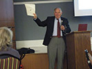 Dr. Minsinger holding a document related to the 1938 Hurricane.